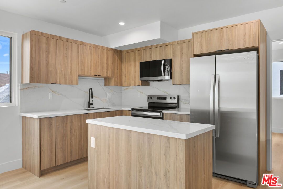 Interior, Kitchen, Marble Walls, Recessed Lighting, Stainless Steel Appliances, Wood Texture Flooring