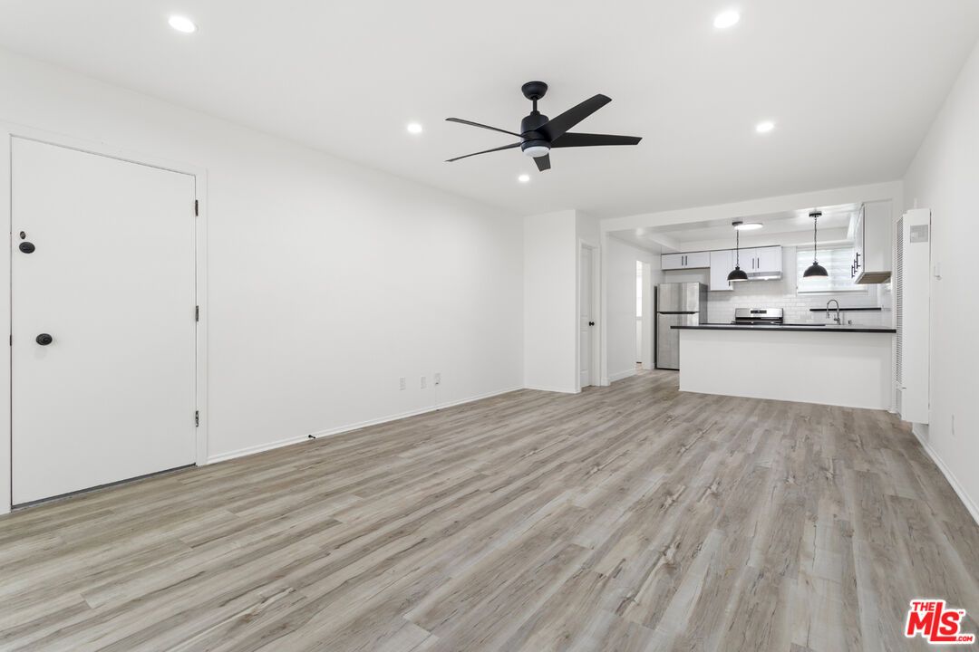 Empty room, Interior, Kitchen, Pendant Lights, Recessed Lighting, Stainless Steel Appliances, Wood Texture Flooring