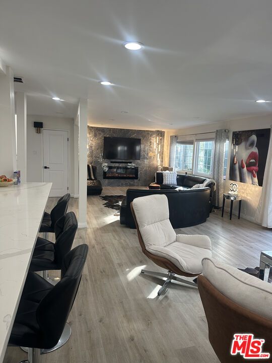 Fireplace, Interior, Living room, Recessed Lighting, Stone Walls, Wood Texture Flooring