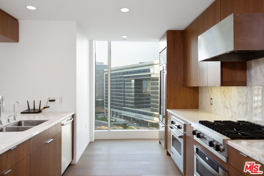Interior, Kitchen, Marble Walls, Recessed Lighting, Stainless Steel Appliances, Wood Texture Flooring