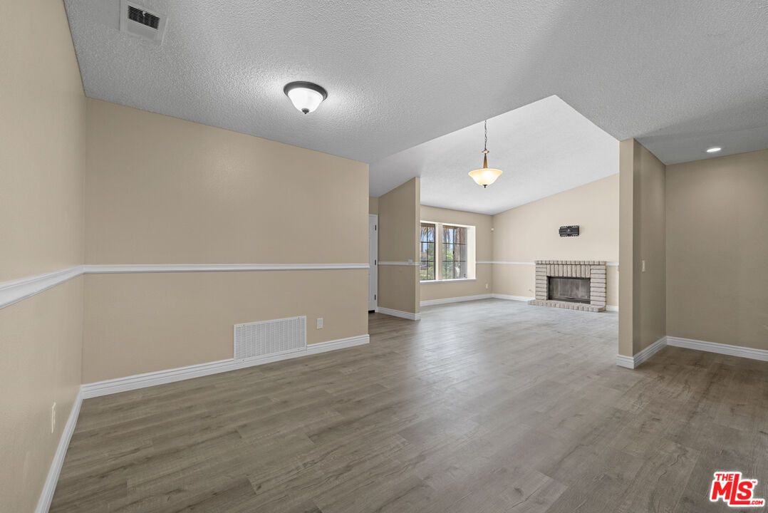 Empty room, Fireplace, Interior, Pendant Lights, Recessed Lighting, Wood Texture Flooring