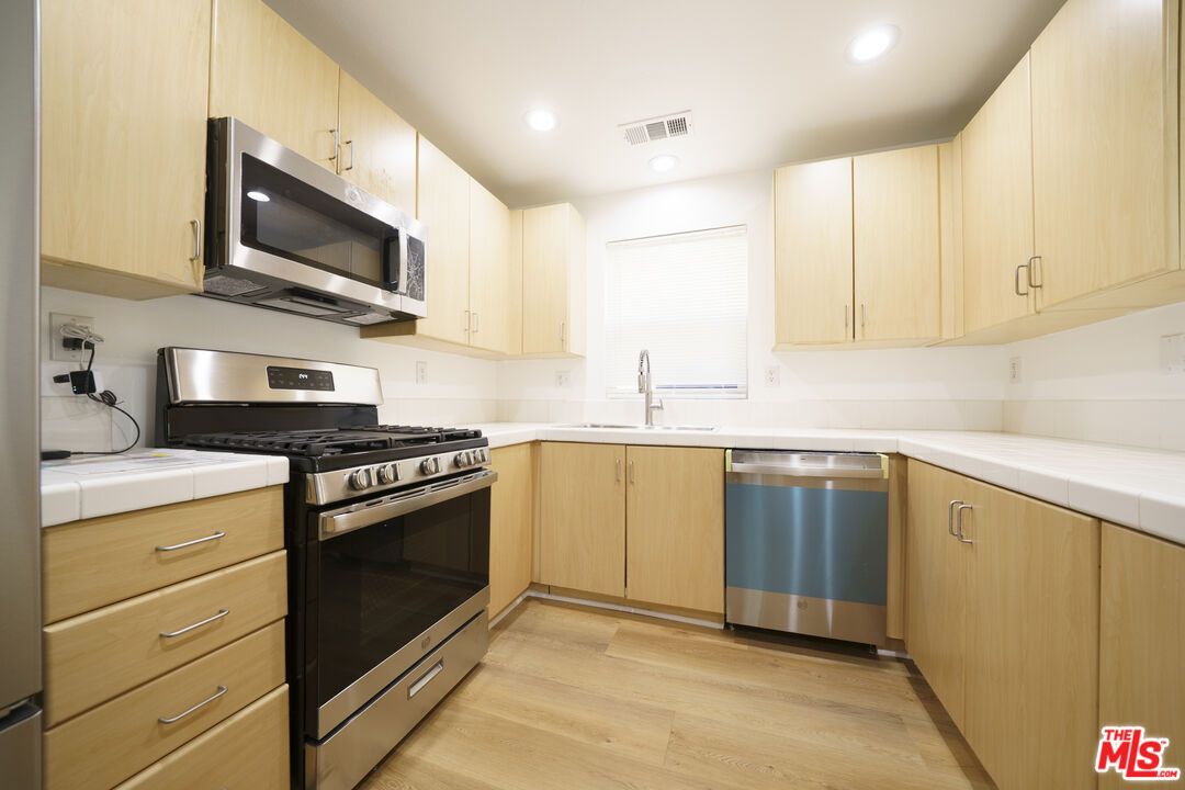 Interior, Kitchen, Recessed Lighting, Stainless Steel Appliances, Tile Countertops, Wood Texture Flooring