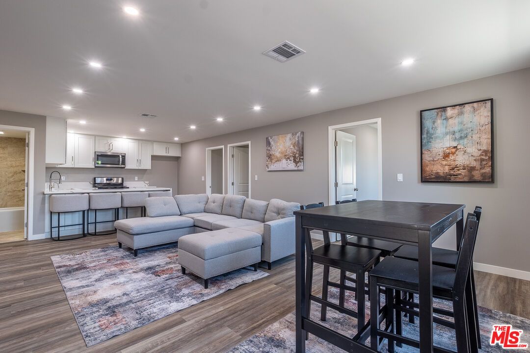 Dining room, Interior, Kitchen, Living room, Recessed Lighting, Stainless Steel Appliances, Wood Texture Flooring