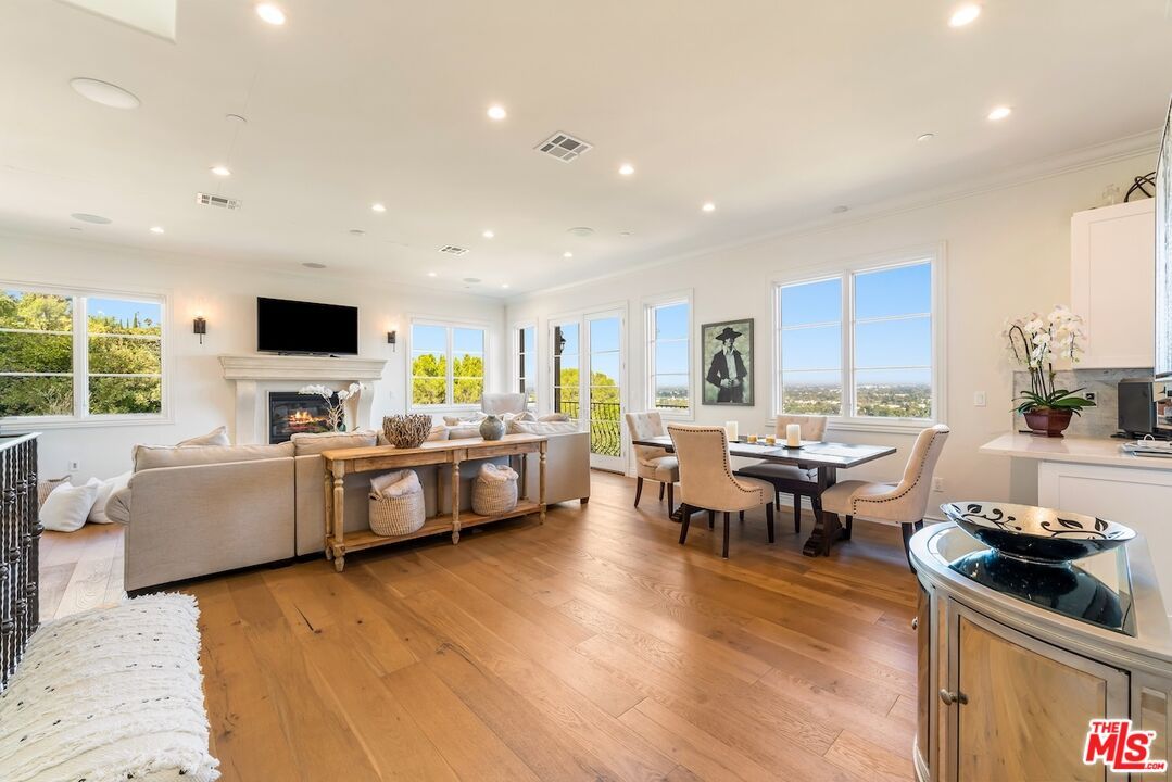 Dining room, Fireplace, Interior, Living room, Recessed Lighting, Wood Texture Flooring