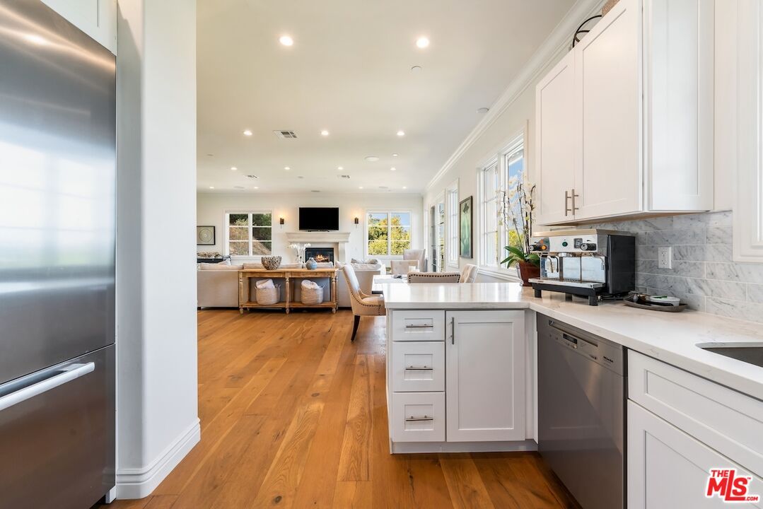 Dining room, Fireplace, Interior, Kitchen, Living room, Recessed Lighting, Stainless Steel Appliances, Wood Texture Flooring