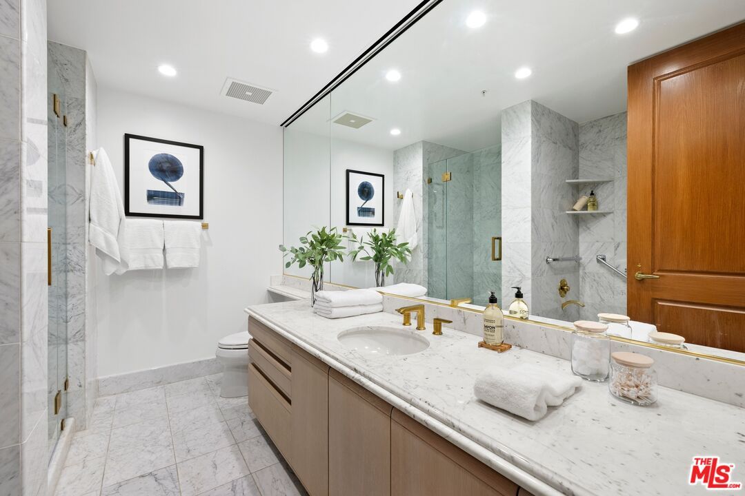 Bathroom, Dual Sink Vanities, Glass Shower, Interior, Marble, Marble Walls, Recessed Lighting