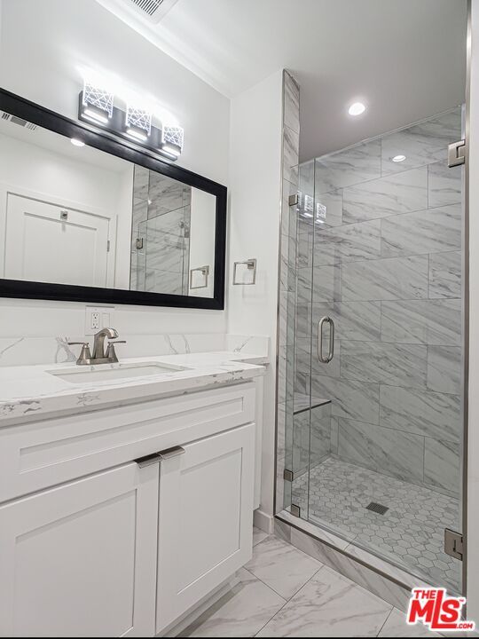 Bathroom, Dual Sink Vanities, Glass Shower, Interior, Marble, Marble Walls, Recessed Lighting