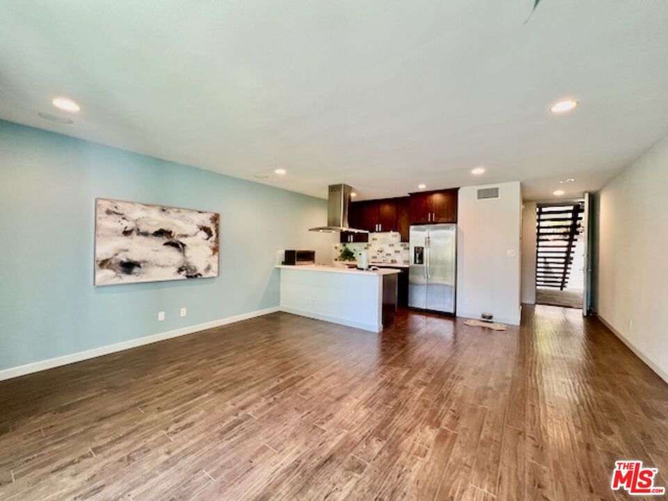 Empty room, Interior, Kitchen, Recessed Lighting, Stainless Steel Appliances, Wood Texture Flooring