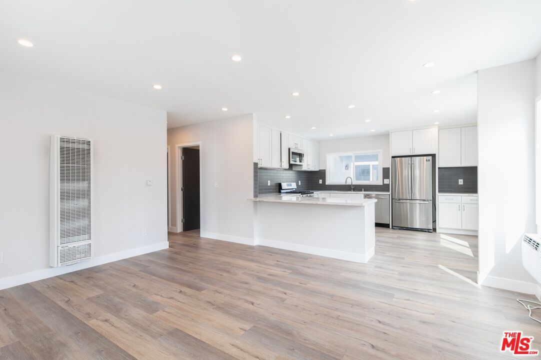 Empty room, Interior, Kitchen, Recessed Lighting, Stainless Steel Appliances, Wood Texture Flooring