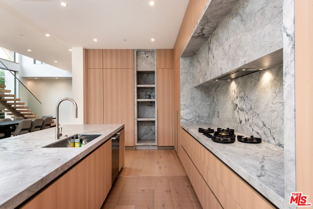 Interior, Kitchen, Marble Walls, Recessed Lighting, Stainless Steel Appliances, Wood Texture Flooring