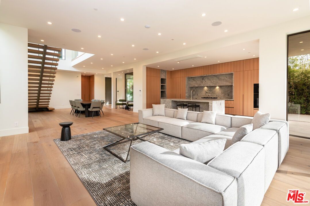 Dining room, Interior, Kitchen, Living room, Marble Walls, Recessed Lighting, Stainless Steel Appliances, Wood Texture Flooring, Wooden Walls