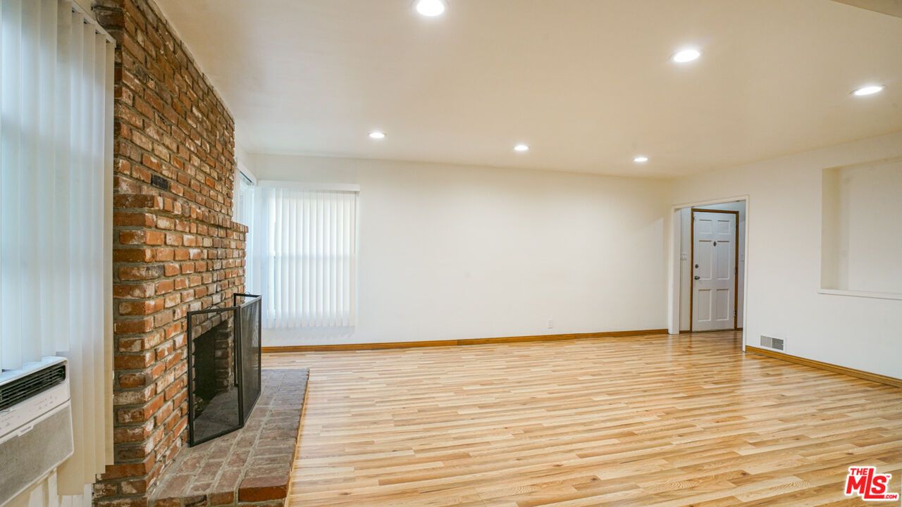 Empty room, Fireplace, Interior, Recessed Lighting, Stone Walls, Wood Texture Flooring