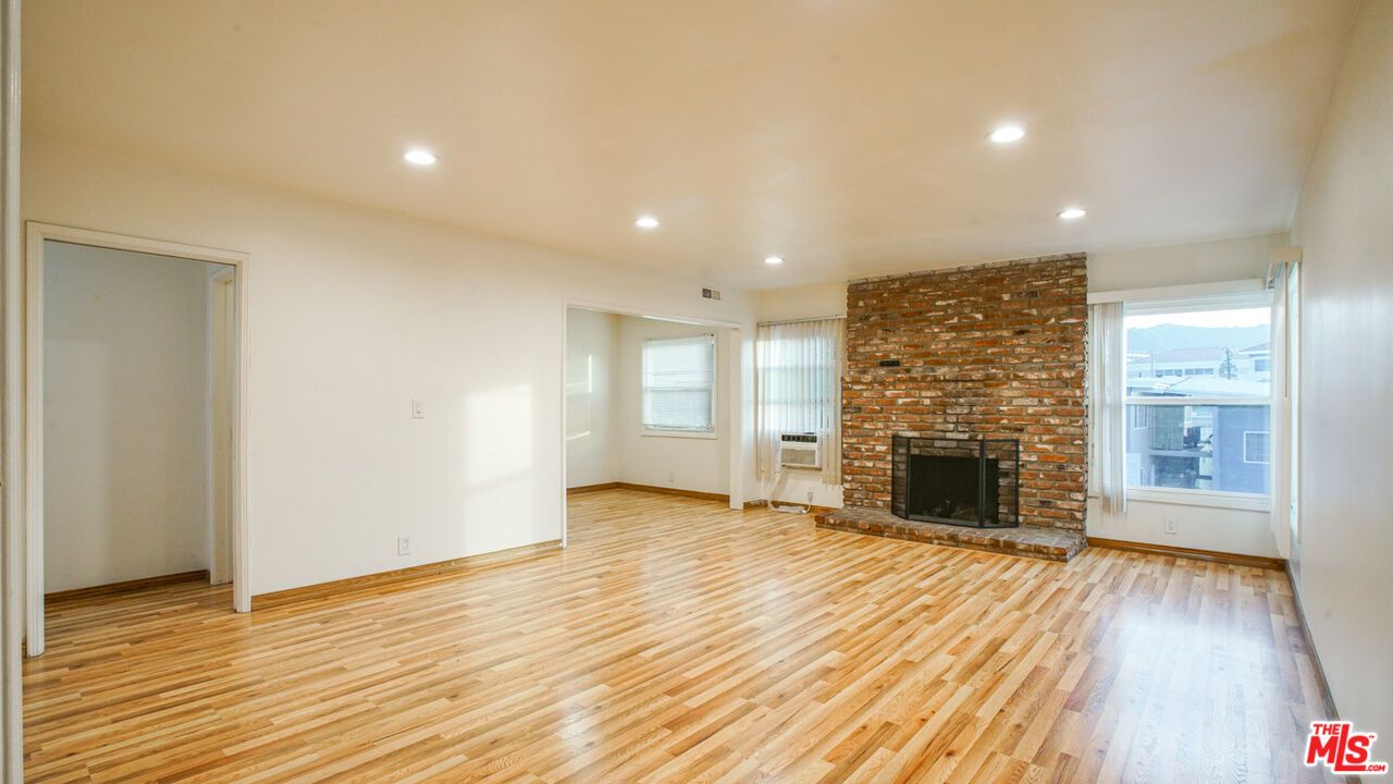 Empty room, Fireplace, Interior, Recessed Lighting, Stone Walls, Wood Texture Flooring