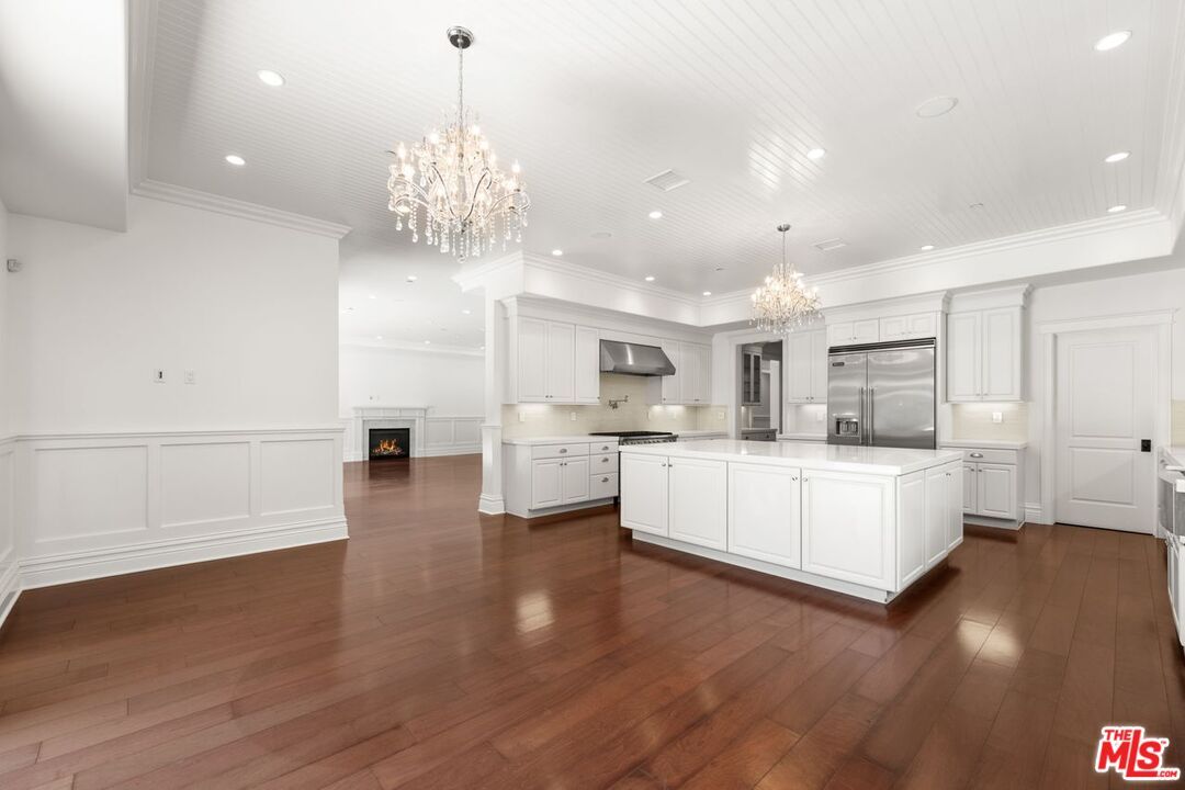 Chandelier, Fireplace, Interior, Kitchen, Recessed Lighting, Stainless Steel Appliances, Wood Texture Flooring