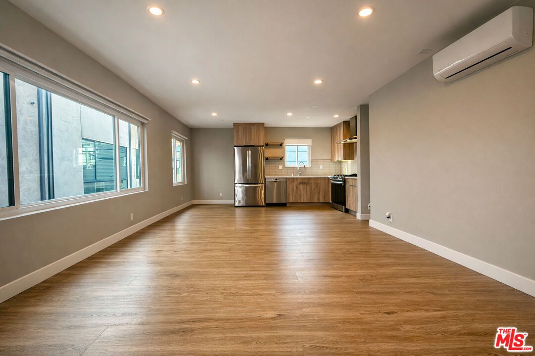 Empty room, Interior, Kitchen, Recessed Lighting, Stainless Steel Appliances, Wood Texture Flooring