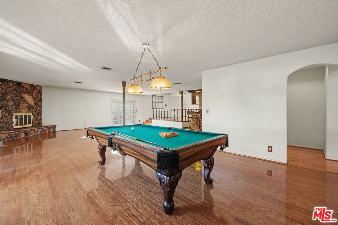 Billiard Table, Chandelier, Game Room, Interior, Pendant Lights, Stone Walls, Wood Texture Flooring