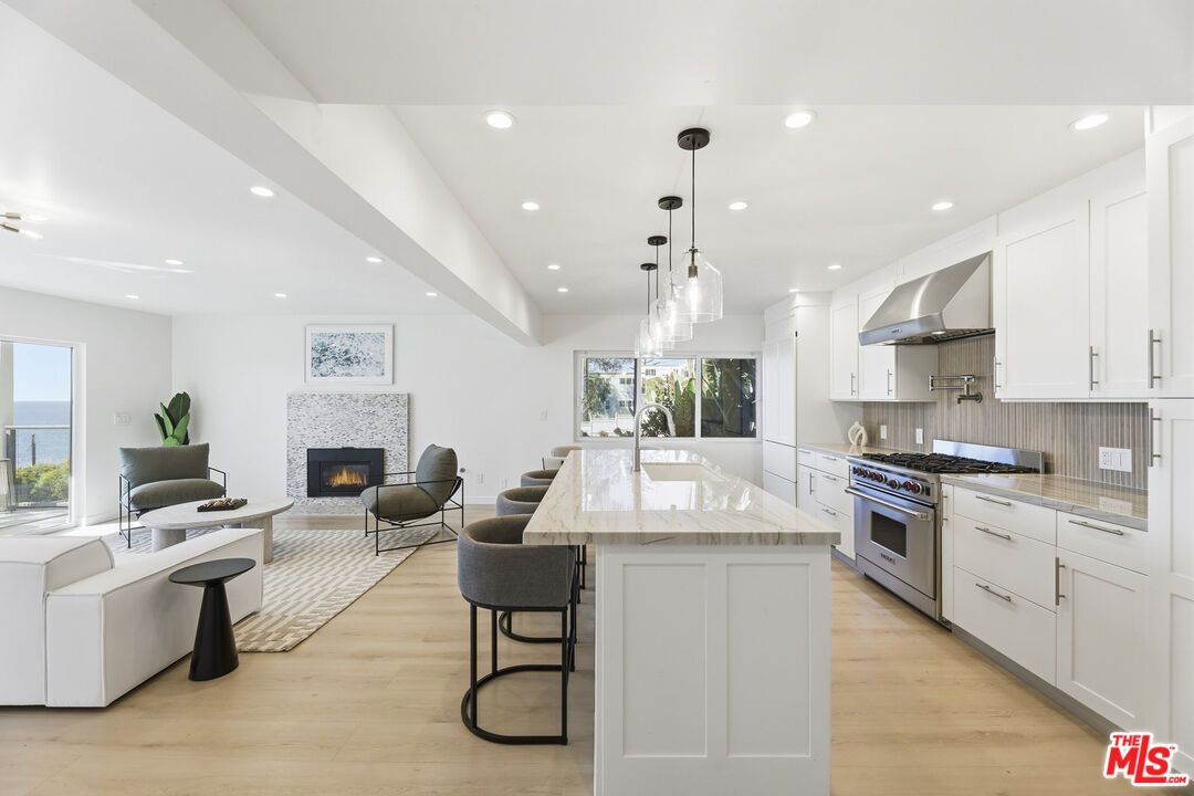 Fireplace, Interior, Kitchen, Living room, Pendant Lights, Recessed Lighting, Stainless Steel Appliances, Water, Wood Texture Flooring