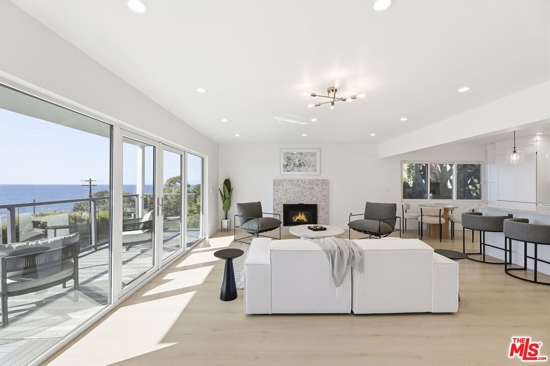 Dining room, Fireplace, Interior, Living room, Pendant Lights, Recessed Lighting, Water, Wood Texture Flooring