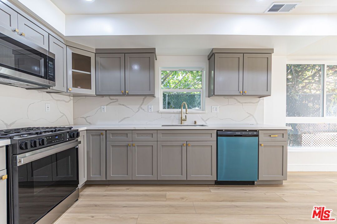 Interior, Kitchen, Marble Walls, Recessed Lighting, Stainless Steel Appliances, Wood Texture Flooring