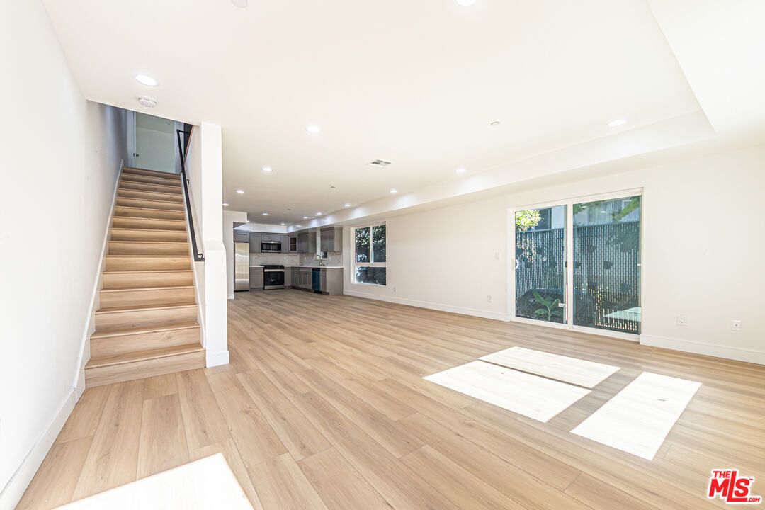 Empty room, Interior, Kitchen, Recessed Lighting, Stainless Steel Appliances, Wood Texture Flooring