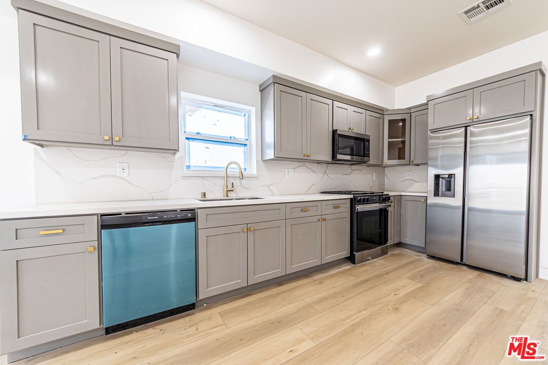 Interior, Kitchen, Marble Walls, Recessed Lighting, Stainless Steel Appliances, Wood Texture Flooring