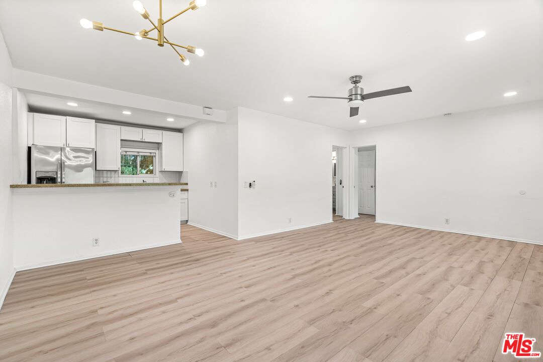 Empty room, Interior, Kitchen, Pendant Lights, Recessed Lighting, Stainless Steel Appliances, Wood Texture Flooring