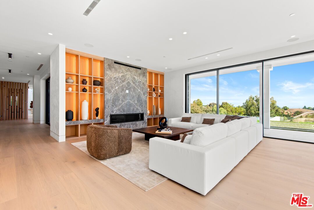 Fireplace, Interior, Living room, Marble Walls, Recessed Lighting, Wood Texture Flooring