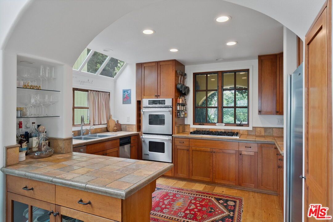 Interior, Kitchen, Recessed Lighting, Stainless Steel Appliances, Tile Countertops, Wood Texture Flooring