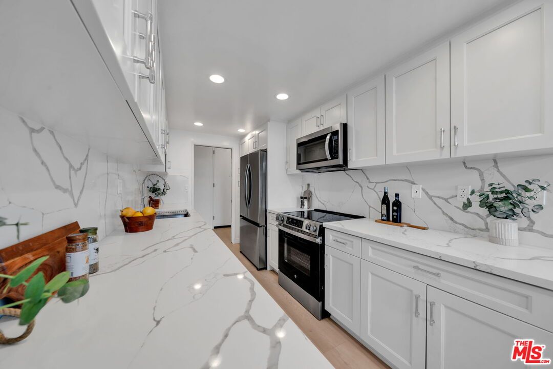 Interior, Kitchen, Marble Walls, Recessed Lighting, Stainless Steel Appliances, Wood Texture Flooring