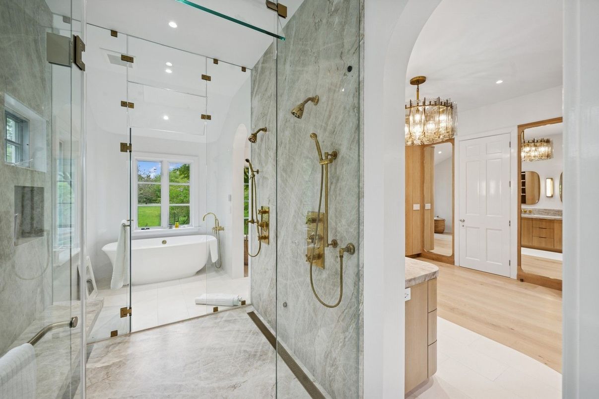 Bathroom, Chandelier, Free Standing Baths, Glass Shower, Interior, Marble Walls, Recessed Lighting, Wood Texture Flooring