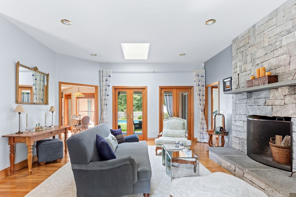 Fireplace, Interior, Living room, Recessed Lighting, Stone Walls, Wood Texture Flooring