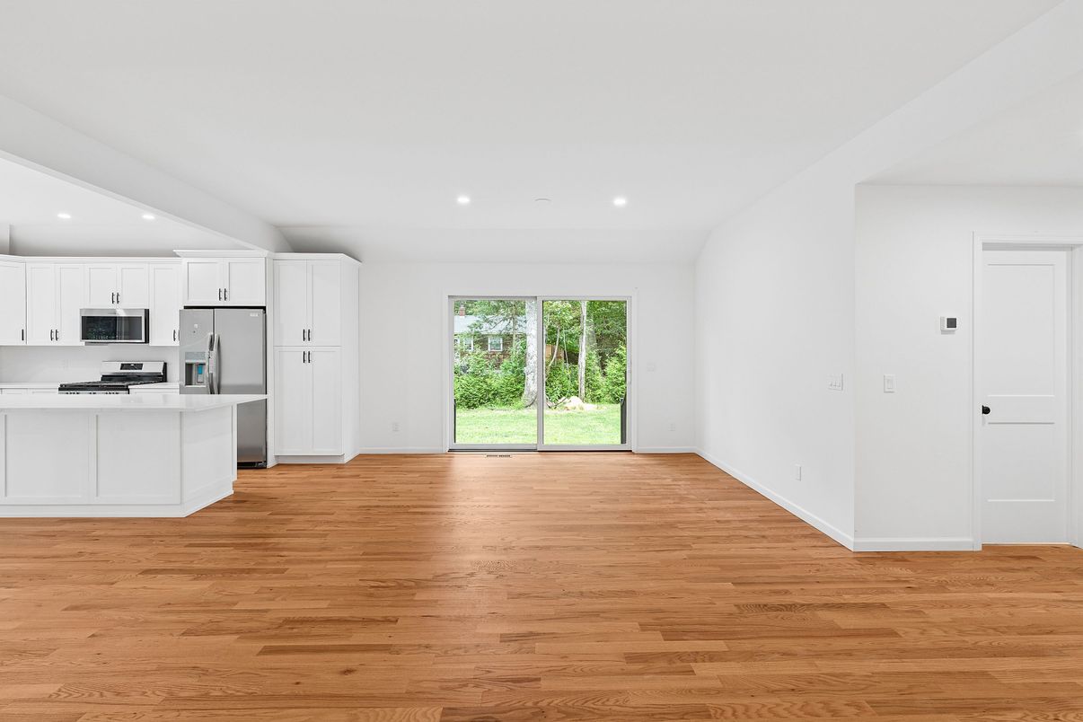 Empty room, Interior, Kitchen, Recessed Lighting, Stainless Steel Appliances, Wood Texture Flooring