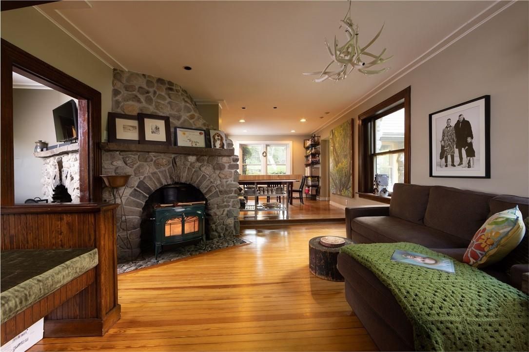 Dining room, Fireplace, Interior, Living room, Recessed Lighting, Stone Walls, Wood Texture Flooring
