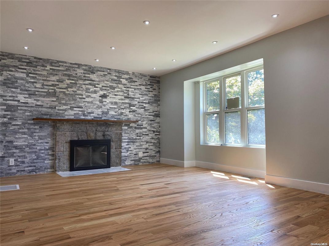 Empty room, Fireplace, Interior, Recessed Lighting, Stone Walls, Wood Texture Flooring