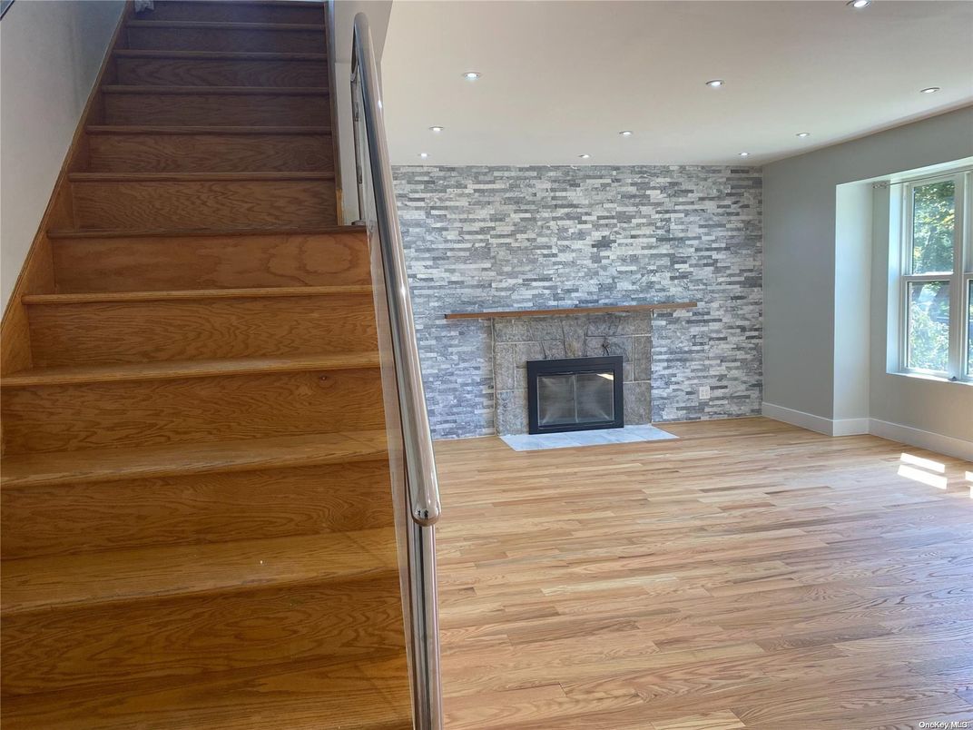 Empty room, Fireplace, Interior, Recessed Lighting, Stone Walls, Wood Texture Flooring