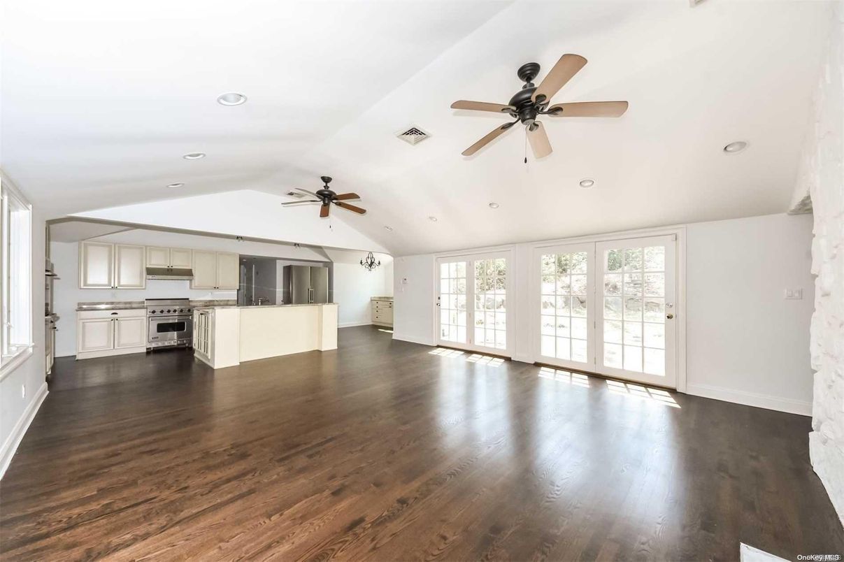 Empty room, Interior, Kitchen, Recessed Lighting, Stainless Steel Appliances, Wood Texture Flooring