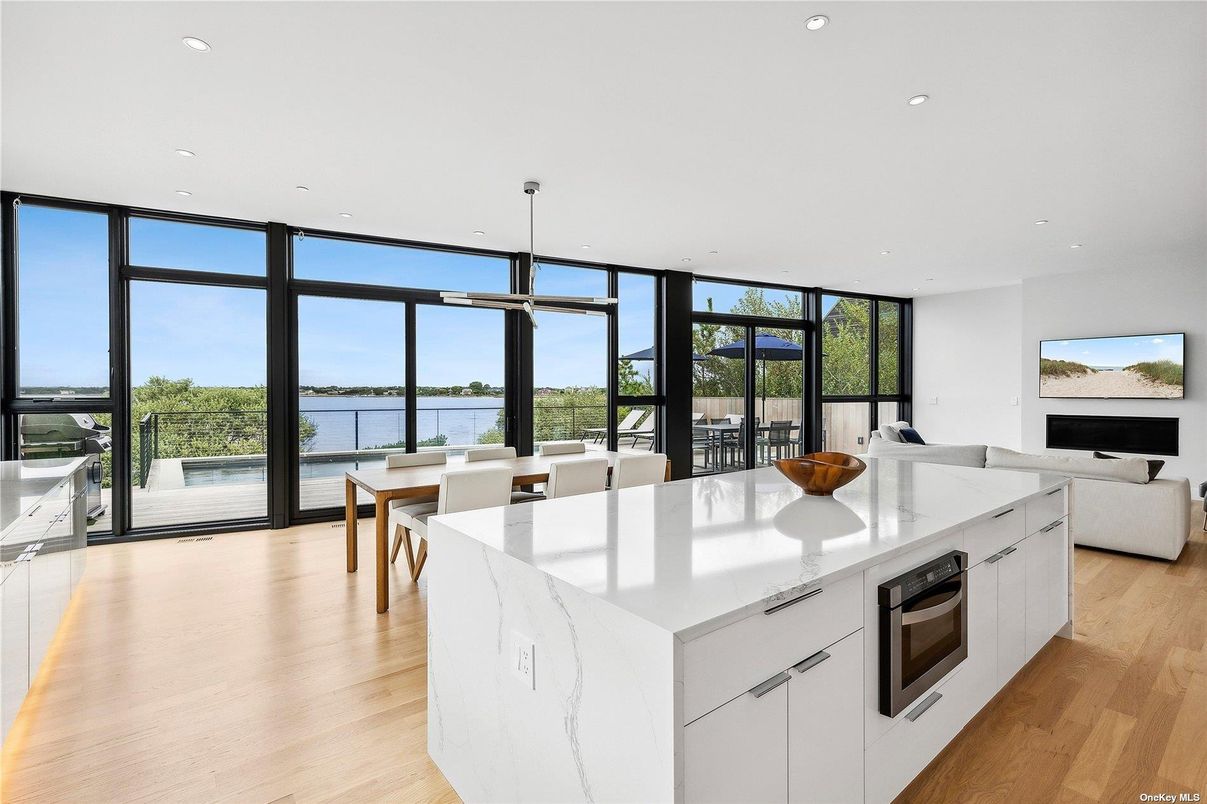 Dining room, Fireplace, Interior, Kitchen, Living room, Pendant Lights, Recessed Lighting, Water, Wood Texture Flooring