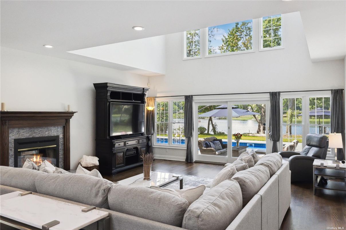 Fireplace, Interior, Living room, Recessed Lighting, Water, Wood Texture Flooring