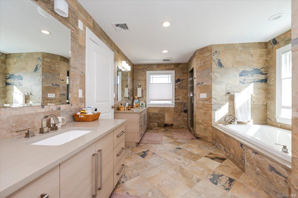Bathroom, Dual Sink Vanities, Glass Shower, Interior, Recessed Lighting, Stone Walls