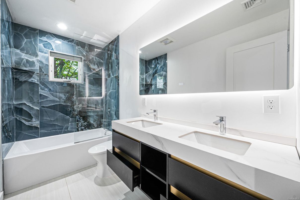 Bathroom, Dual Sink Vanities, Glass Shower, Interior, Marble Walls, Recessed Lighting