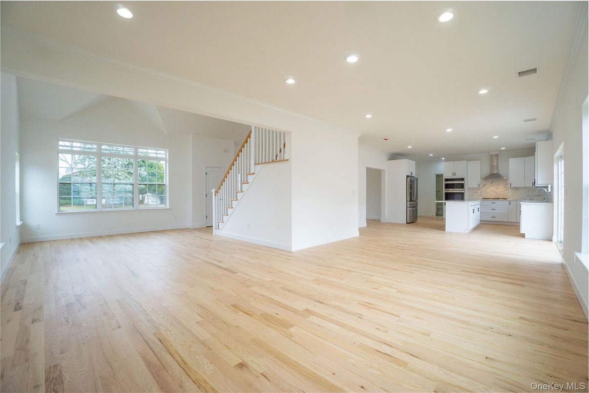 Empty room, Interior, Kitchen, Recessed Lighting, Stainless Steel Appliances, Wood Texture Flooring