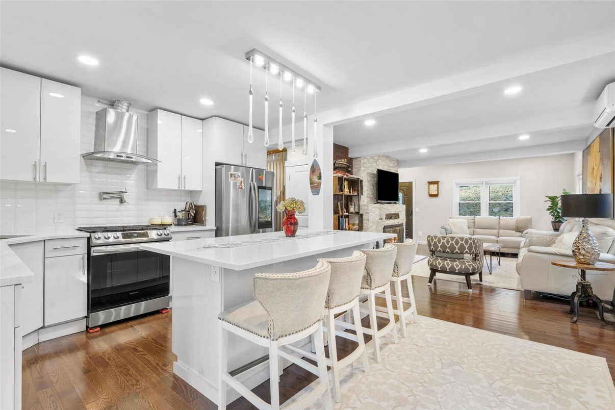 Fireplace, Interior, Kitchen, Living room, Pendant Lights, Recessed Lighting, Stainless Steel Appliances, Stone Walls, Wood Texture Flooring