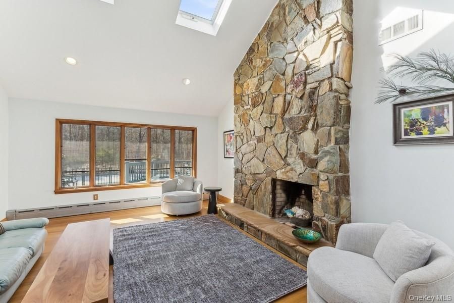 Fireplace, Interior, Living room, Recessed Lighting, Stone Walls, Wood Texture Flooring