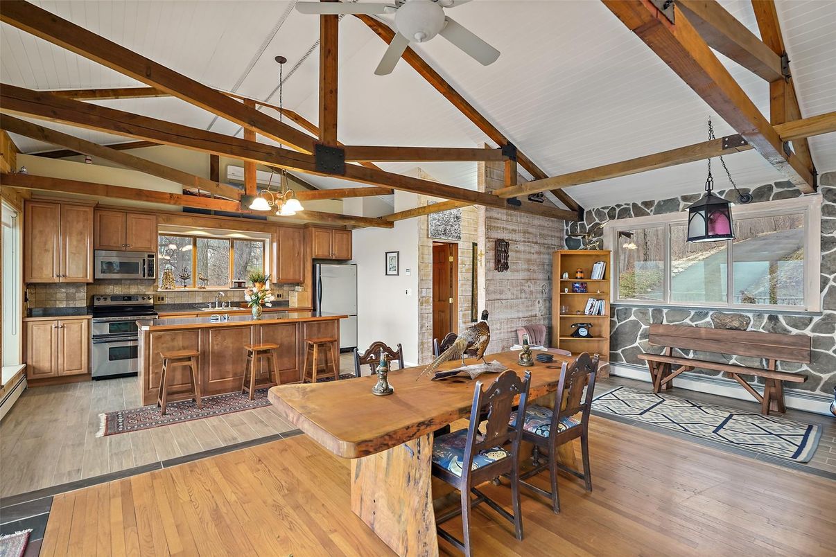 Chandelier, Dining room, Interior, Kitchen, Pendant Lights, Stainless Steel Appliances, Stone Walls, Wooden Beams, Wood Texture Flooring