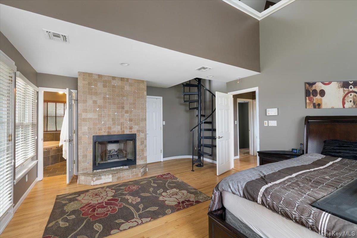 Bedroom, Fireplace, Interior, Recessed Lighting, Wood Texture Flooring