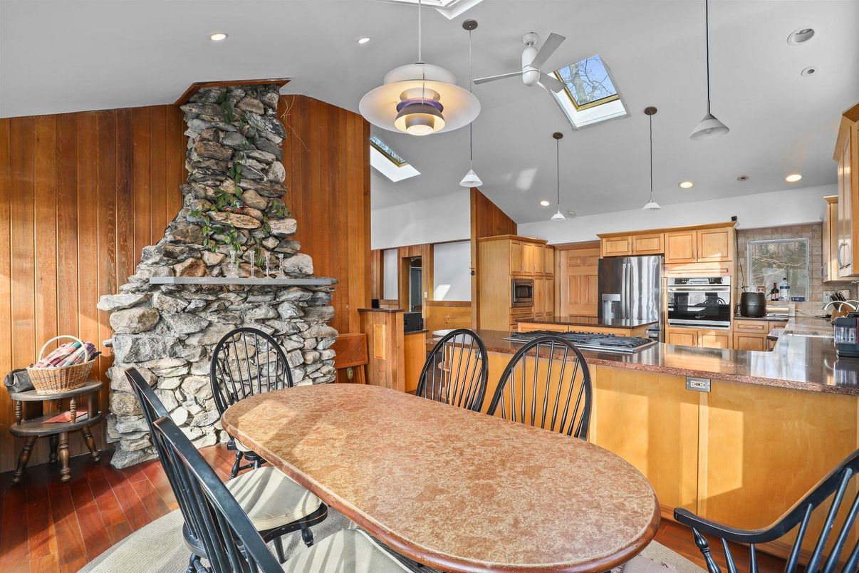 Dining room, Fireplace, Interior, Kitchen, Pendant Lights, Recessed Lighting, Stainless Steel Appliances, Stone Walls, Wood Texture Flooring