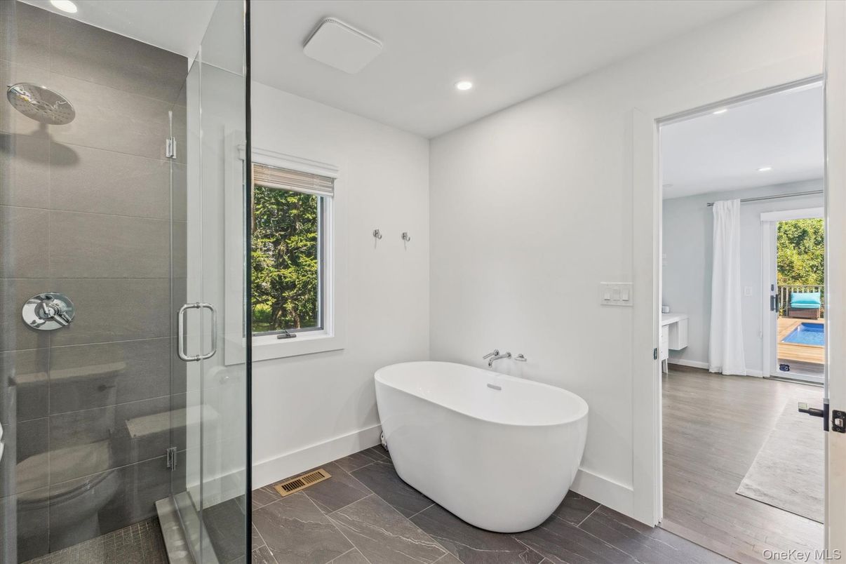 Bathroom, Free Standing Baths, Glass Shower, Interior, Recessed Lighting, Wood Texture Flooring