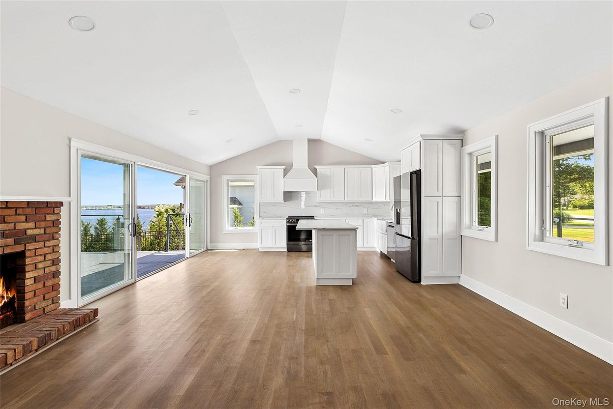 Empty room, Fireplace, Interior, Kitchen, Recessed Lighting, Water, Wood Texture Flooring