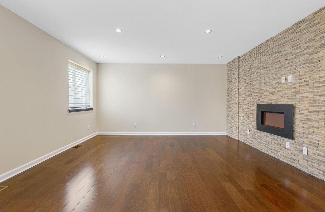 Empty room, Fireplace, Interior, Recessed Lighting, Stone Walls, Wood Texture Flooring