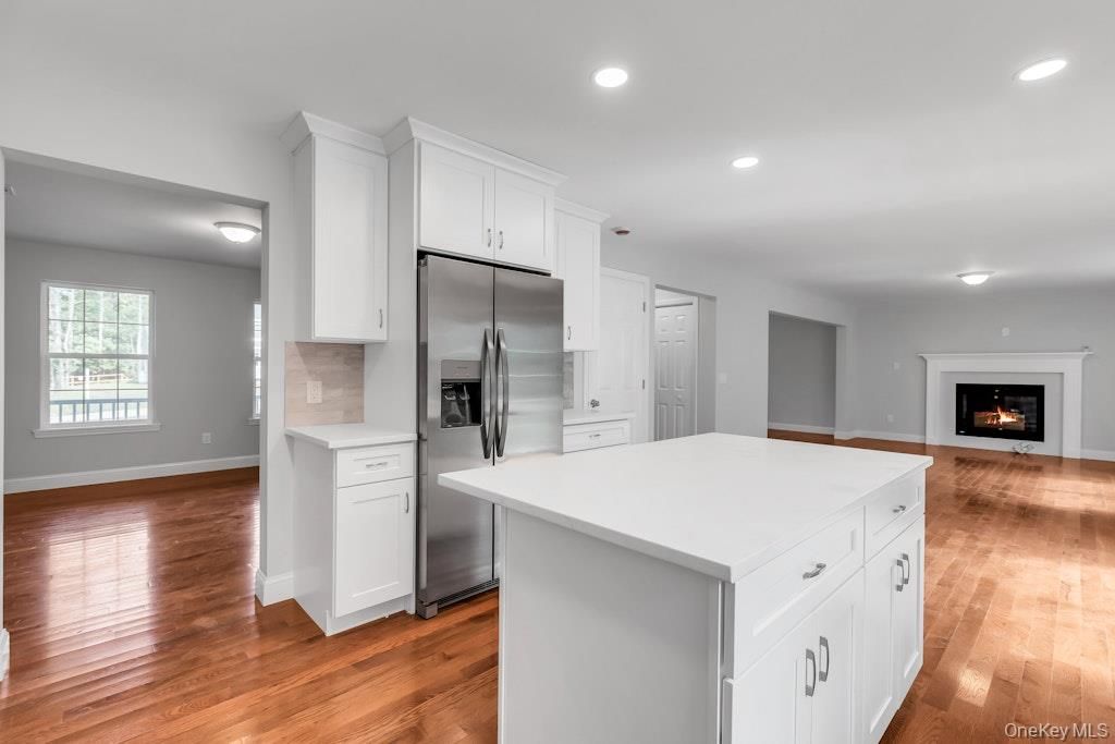 Fireplace, Interior, Kitchen, Recessed Lighting, Stainless Steel Appliances, Wood Texture Flooring